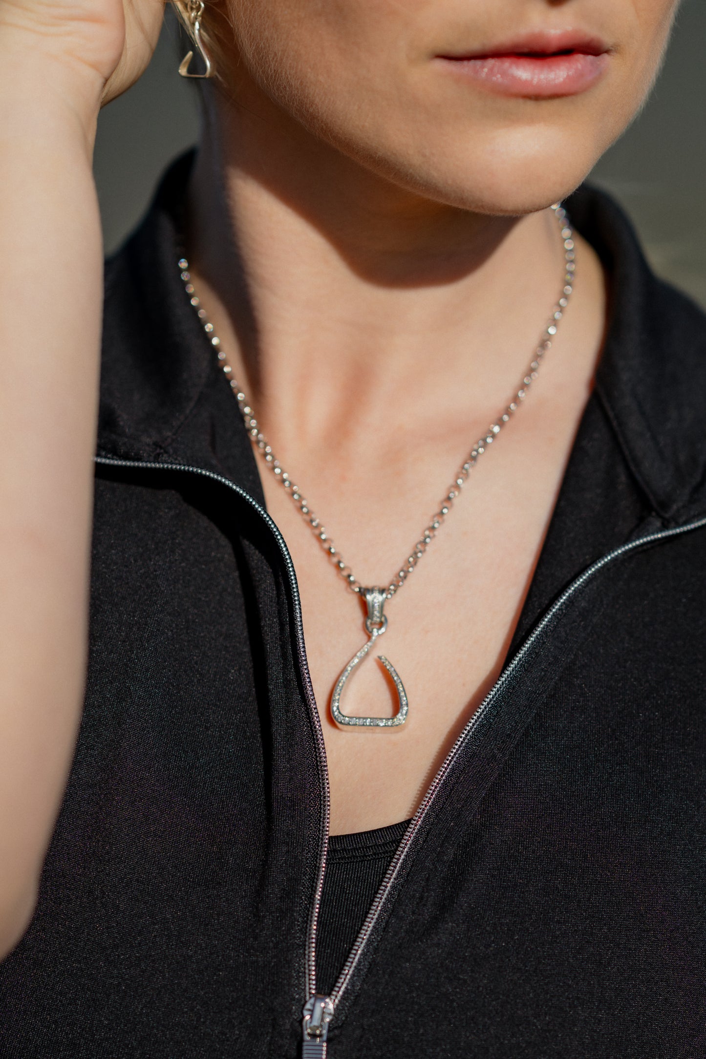 White gold Jump Stirrup Pendant, set with 1/2 carat of white brilliant cut diamonds. Paired beautifully with a white gold round belcher chain from Crawford Hill.