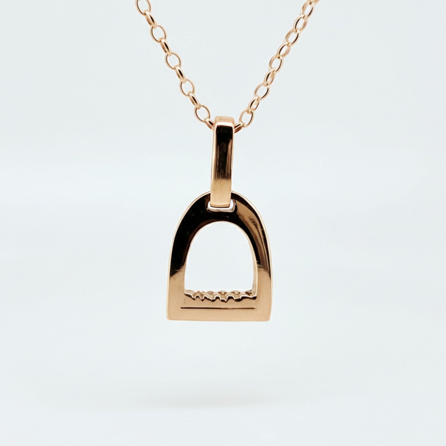 Product photo of small rose gold stirrup necklace. Made to be worn by horse riders by Crawford Hill Equestrian Jewellery.
