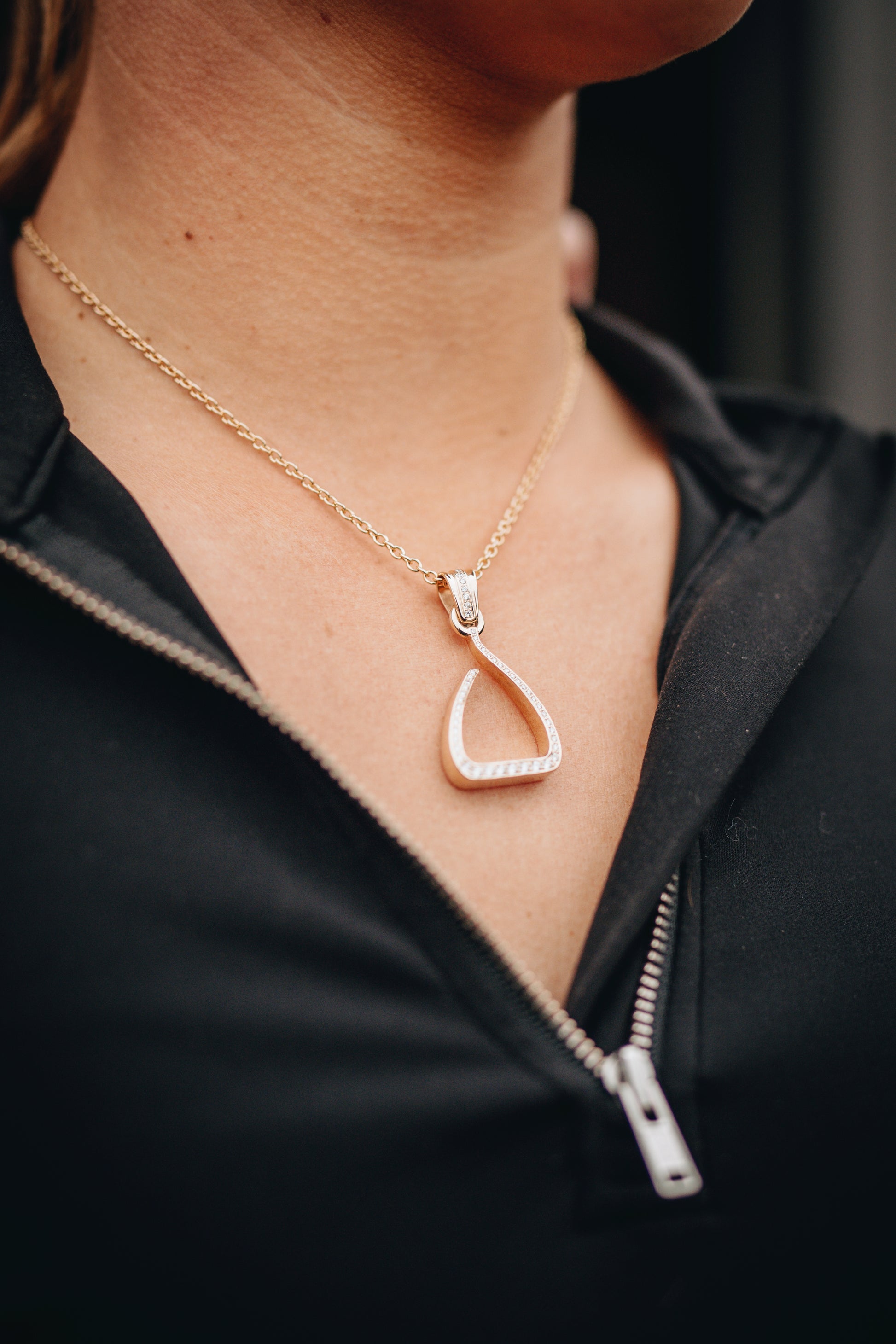 Yellow gold Jump Stirrup Pendant, set with 1/2 carat of round brilliant cut white diamonds. Paired beautifully with a yellow gold calbe chain. 