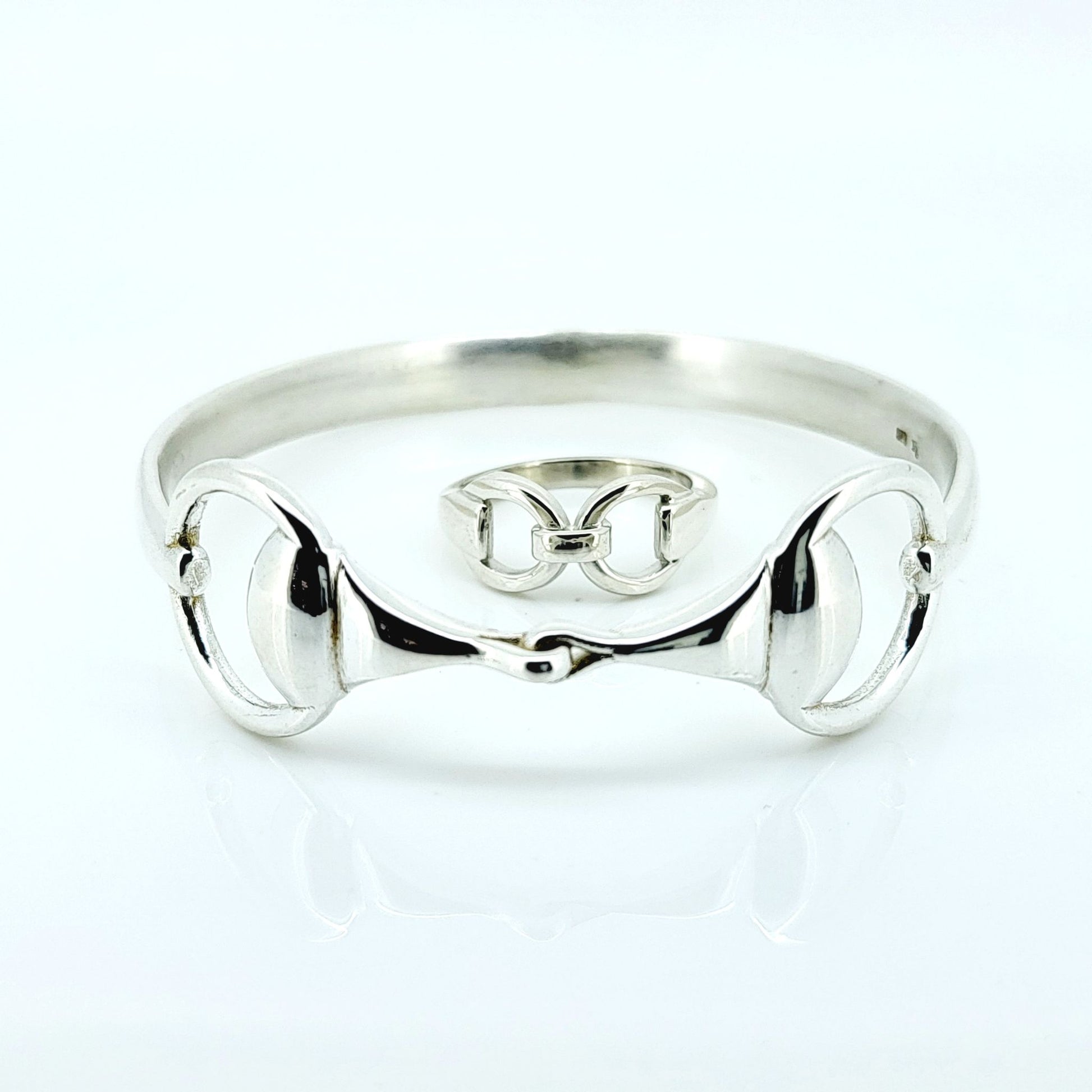 Photo of a silver horse bit snaffle bangle and ring, made by Crawford Hill Equestrian Jewellery. 