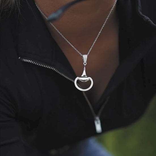 Video of an equestrian horse rider earing a white gold, diamond set half snaffle horse bit necklace by Crawford Hill Equestrian Jewellery. 