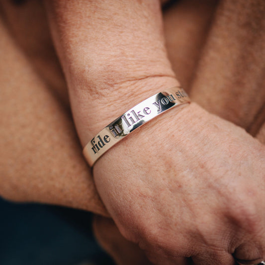 Horse rider wearing a sterling silver "Ride It like You Stole It" Bangle made by Crawford Hill Equestrian Jewellery.